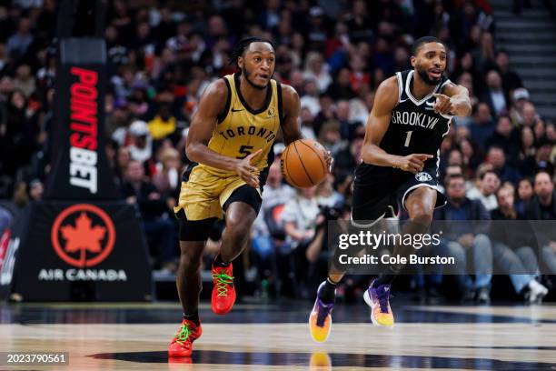 Immanuel Quickley of the Toronto Raptors dribbles against Mikal Bridges of the Brooklyn Nets in the first half of their NBA game at Scotiabank Arena...