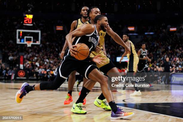 Mikal Bridges of the Brooklyn Nets drives to the net against Scottie Barnes of the Toronto Raptors in the second half of their NBA game at Scotiabank...