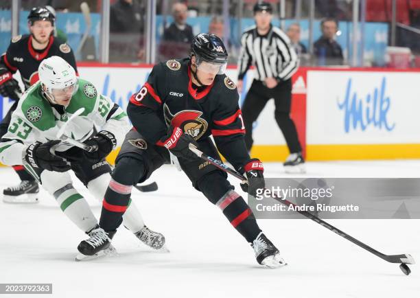 Tim Stützle of the Ottawa Senators controls the puck against Wyatt Johnston of the Dallas Stars during the third period at Canadian Tire Centre on...