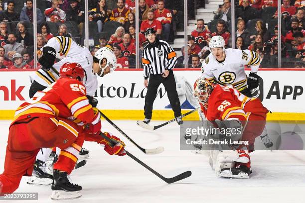 Pavel Zacha of the Boston Bruins takes a shot on Jacob Markstrom of the Calgary Flames during the second period of an NHL game at Scotiabank...