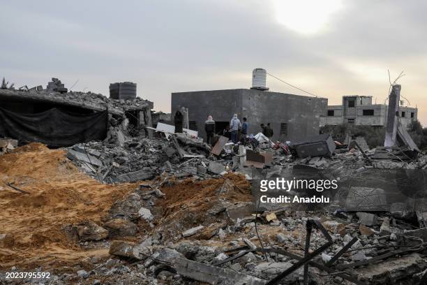 Palestinian people inspect the destroyed and damaged structures after Israeli army targeted a house belonging to the Carhun and Najim families in...