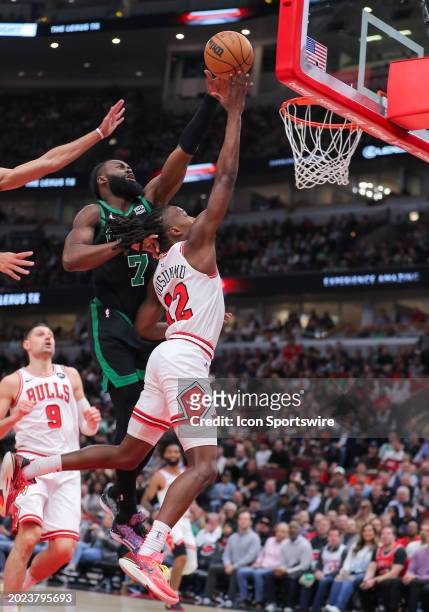 Jaylen Brown of the Boston Celtics blocks Ayo Dosunmu of the Chicago Bulls layup during the second half at United Center on February 22, 2024 in...