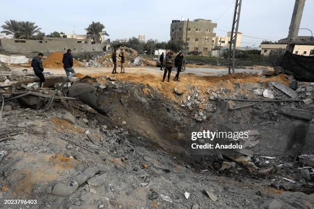 Palestinian people inspect the destroyed and damaged structures after Israeli army targeted a house belonging to the Carhun and Najim families in...