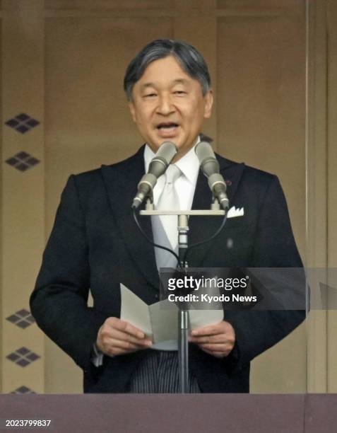 Japanese Emperor Naruhito delivers a speech as he appears on a balcony at the Imperial Palace in Tokyo on Feb. 23 for a crowd gathered to celebrate...