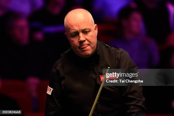 John Higgins of England reacts in the first round match against Ding Junhui of China on day one of 2024 Players Championship at Telford International...