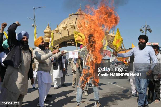 Farmers shout slogans as they burn an effigy representing Home Minister of Haryana Sate Anil Vij , Haryana Chief Minister Manohar Lal Khattar and...