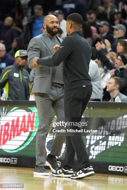 Head coach Kim English of the Providence Friars and head coach Kyle Neptune of the Villanova Wildcats shake hands during a college basketball game at...