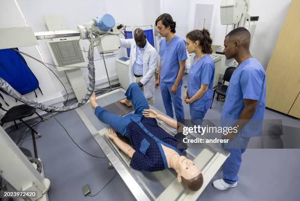 doctor teaching medical students how to take an x-ray image - mannequin stock pictures, royalty-free photos & images