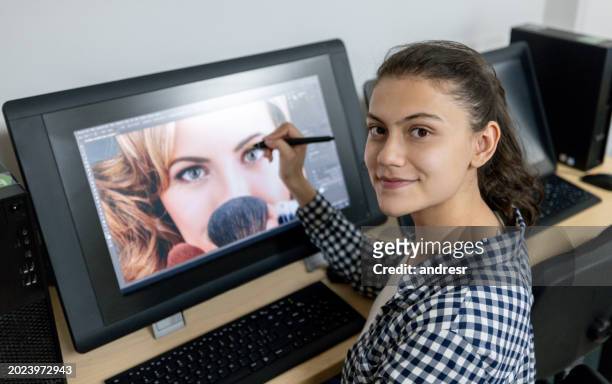 graphic design student retouching a photo using a computer at the university - multimedia learning stock pictures, royalty-free photos & images