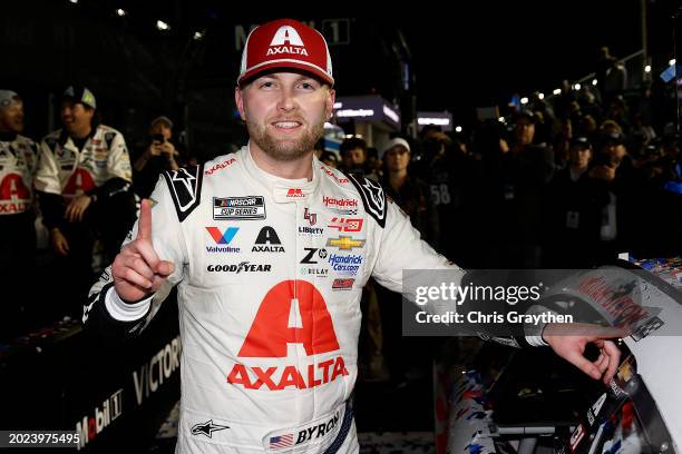 William Byron, driver of the Axalta Chevrolet, poses with the winner sticker on his car after winning the NASCAR Cup Series Daytona 500 at Daytona...