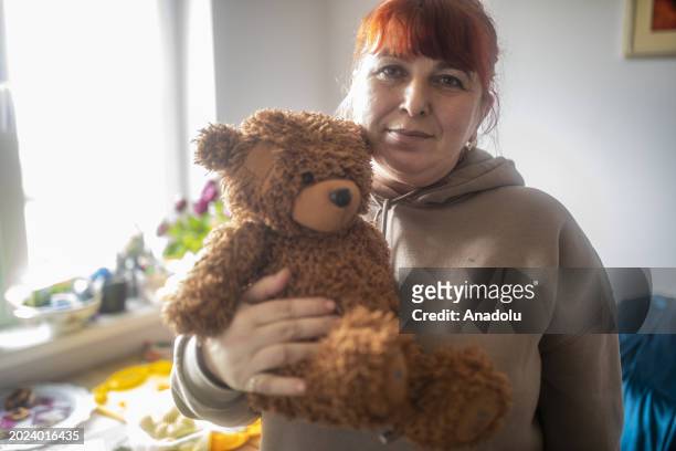 Natalia, living in Gostomel, a town located near Kyiv and it has been heavily impacted by the ongoing attacks, holds a teddy bear at her house and...
