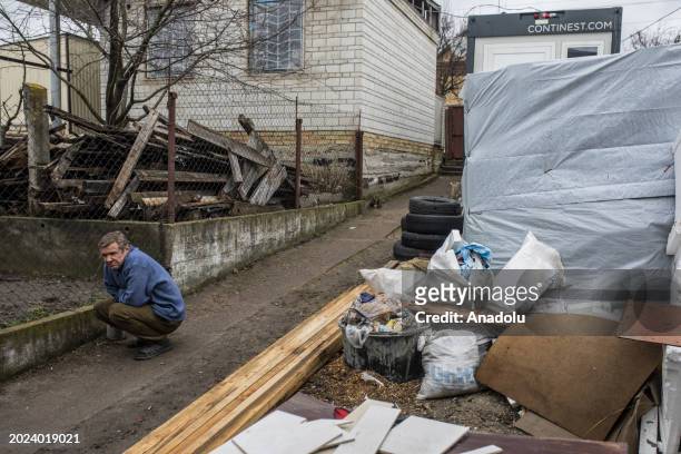 Citizen sits near a destroyed area, living in Gostomel, a town located near Kyiv and it has been heavily impacted by the ongoing attacks, stands next...