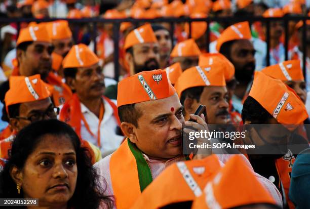 Party worker talks on his mobile phone at a Bharatiya Janata Party party workers conference in Mumbai. Bharatiya Janata Party National President J.P....