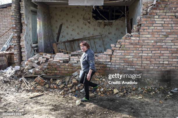 Woman walks past damaged buildings as Kyiv Oblast, surrounding the capital of Ukraine, still bears the scars of the war as the country marks the 2nd...