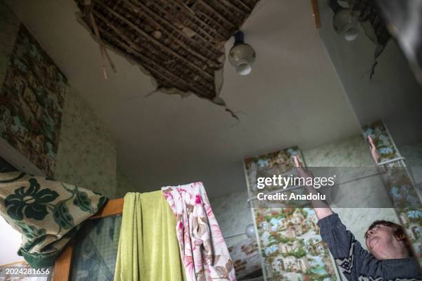 Woman shows damaged parts of her house as Kyiv Oblast, surrounding the capital of Ukraine, still bears the scars of the war as the country marks the...