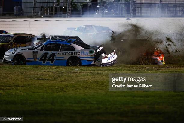 Brennan Poole, driver of the Finance Pro Plus Chevrolet, and Justin Allgaier, driver of the BRANDT Chevrolet, spin into the infield grass after an...