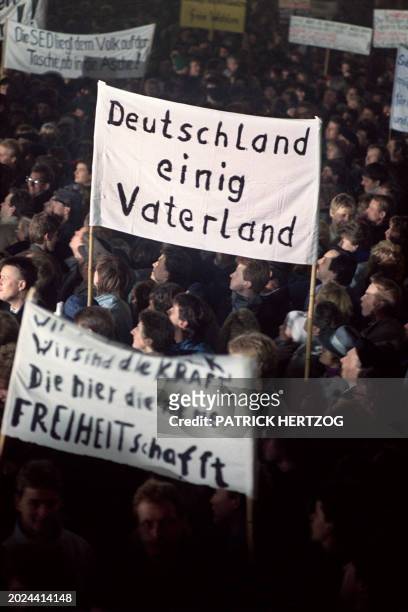 Among more than 100,000 people demonstrate in Leipzig on November 20 some holding banner proclaiming "Germany one single fatherland", to call for...
