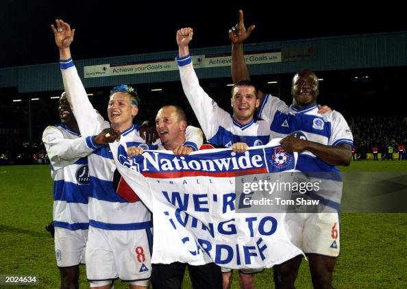 Queens Park Rangers players Paul Furlong, Marc Bircham, manager Ian Holloway, Kevin McLeod, and Dan Shittu celebrate victory Queens Park Rangers players Paul Furlong, Marc Bircham, manager Ian Holloway, Kevin McLeod, and Dan Shittu celebrate victory