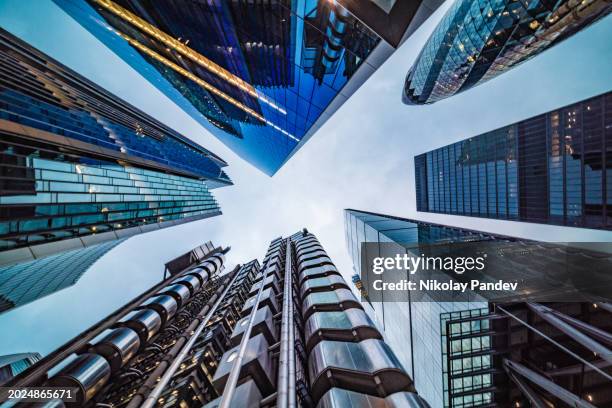 extreme wide angle view directly up in the skyline of the financial district in down town central city of london, united kingdom - creative stock image - finance and economy stock pictures, royalty-free photos & images