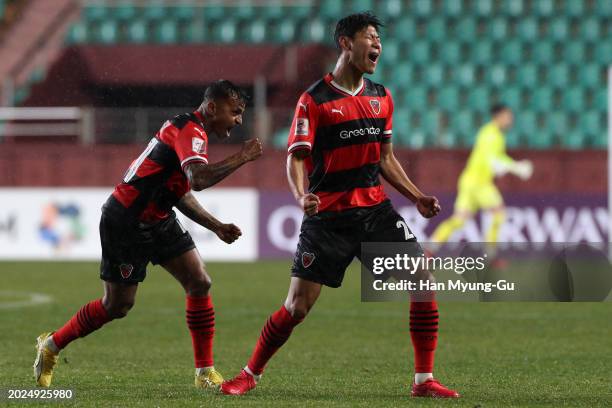 Park Chan-yong of Pohang Steelers celebrates with teammate Wanderson after scoring the team's first goal during the AFC Champions League Round of 16...
