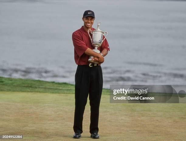 Tiger Woods from the United States holds the United States Golf Association Open Championship trophy after winning the 100th United States Open golf...