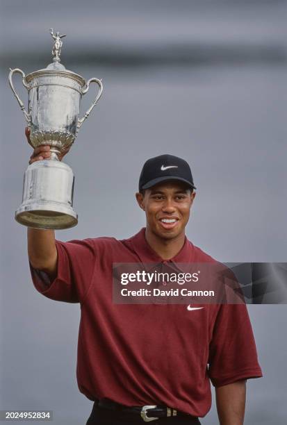 Tiger Woods from the United States lifts the United States Golf Association Open Championship trophy after winning the 100th United States Open golf...