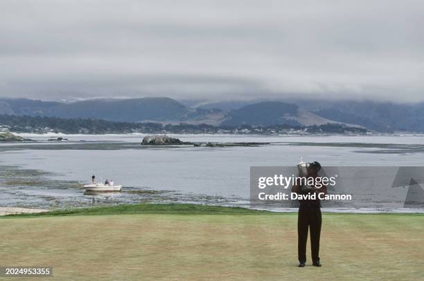 Tiger Woods from the United States kisses the United States Golf Association Open Championship trophy after winning the 100th United States Open golf...