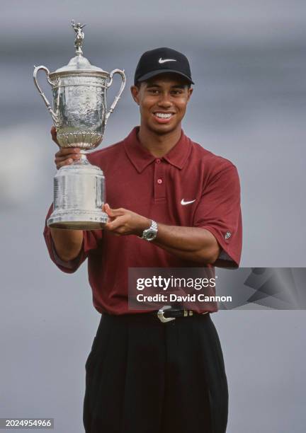 Tiger Woods from the United States lifts the United States Golf Association Open Championship trophy after winning the 100th United States Open golf...