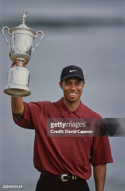 Tiger Woods from the United States lifts the United States Golf Association Open Championship trophy after winning the 100th United States Open golf...