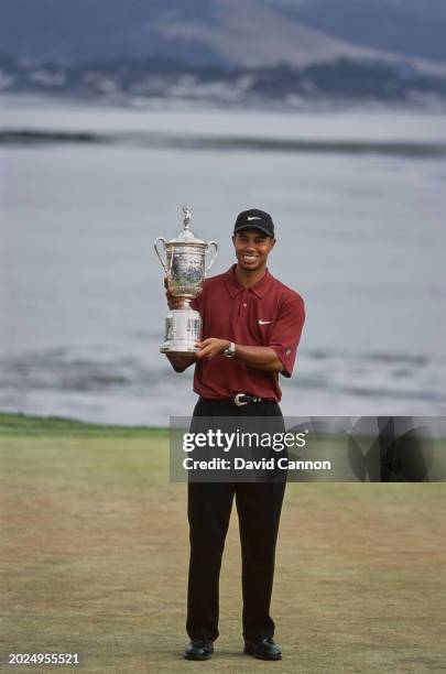 Tiger Woods from the United States holds the United States Golf Association Open Championship trophy after winning the 100th United States Open golf...