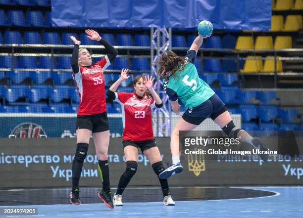 Polina Chernienko №5 of HC Sumy-U fights for the ball against Anastasia Orzhakhovska №55 and Yuliya Poradnyk №23 of HC Spartak Kyiv during the...