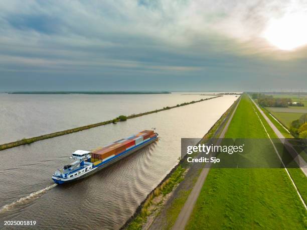 container ship barge sailing on a canal - narrow boat stock pictures, royalty-free photos & images