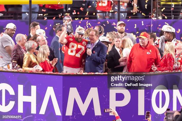 Travis Kelce of Kansas City Chiefs lifts the Heisman-Trophy after the Super Bowl LVIII match between San Francisco 49ers and Kansas City Chiefs at...