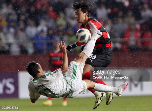 Moon Seon-min of Jeonbuk Hyundai Motors attempts an overhead kick while Kim Jun-ho of Pohang Steelers tries to block during the AFC Champions League...