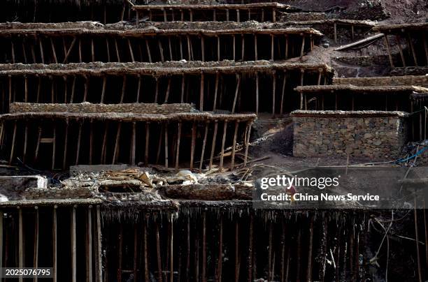 Villagers work at salt pans along the Lancang River on February 20, 2024 in Markam County, Changdu City, Tibet Autonomous Region of China. An ancient...