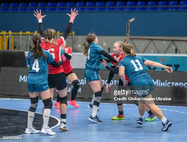 Anastasiya Parkhomenko №4 of HC Spartak Kyiv fights for the ball against Daria Yakubovych №15 and Olga Brusova №11 of HC Sumy-U during the Women's...