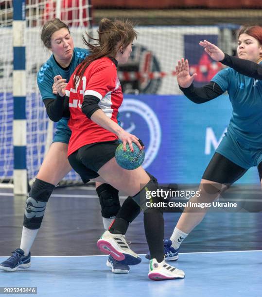 Yuliya Poradnyk №23 of HC Spartak Kyiv fights for the ball against Daria Mygalenko №9 and Alyona Len' №14 of HC Sumy-U during the Women's Handball...