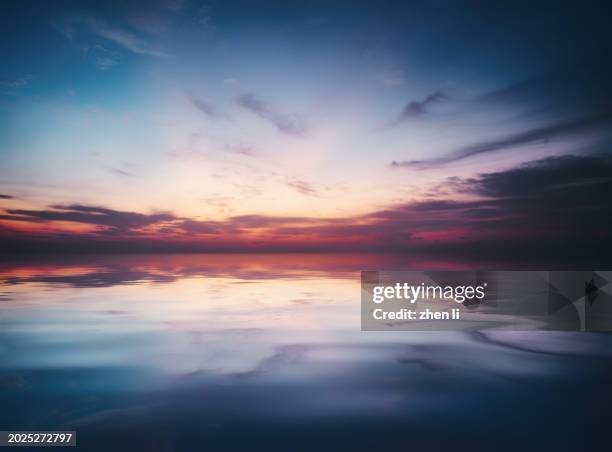 sky reflecting in sea - atmospheric mood stock pictures, royalty-free photos & images