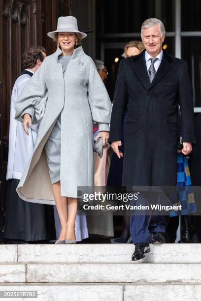 Queen Mathilde and King Philippe of Belgium greet people after the annual mass in memory of deceased members of the Belgian Royal Family at Eglise...