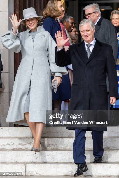 Queen Mathilde and King Philippe of Belgium greet people after the annual mass in memory of deceased members of the Belgian Royal Family at Eglise...