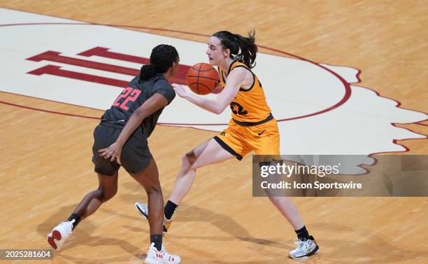 Iowa Hawkeyes guard Caitlin Clark is guarded by Indiana Hoosiers guard Chloe Moore-McNeil on February 22, 2024 at Simon Skjodt in Bloomington, Indiana