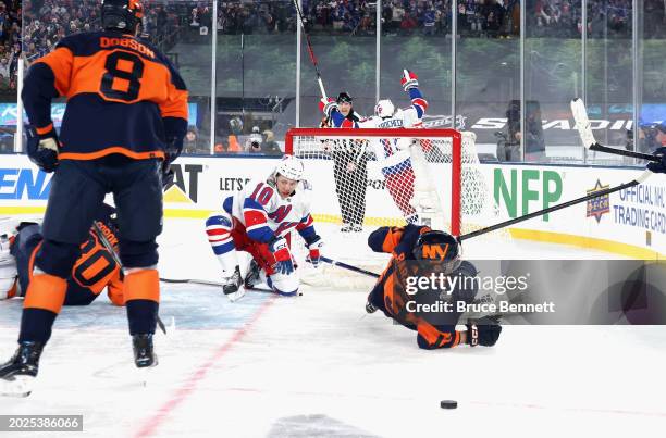 Artemi Panarin of the New York Rangers score sthe game-winning goal in overtime against the New York Islanders during the 2004 Navy Federal Credit...