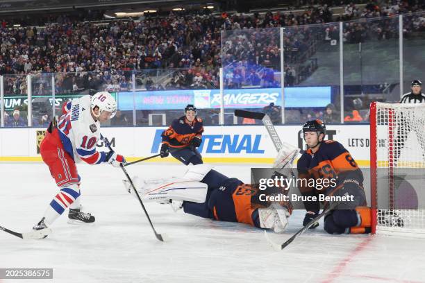 Artemi Panarin of the New York Rangers score sthe game-winning goal in overtime against the New York Islanders during the 2004 Navy Federal Credit...