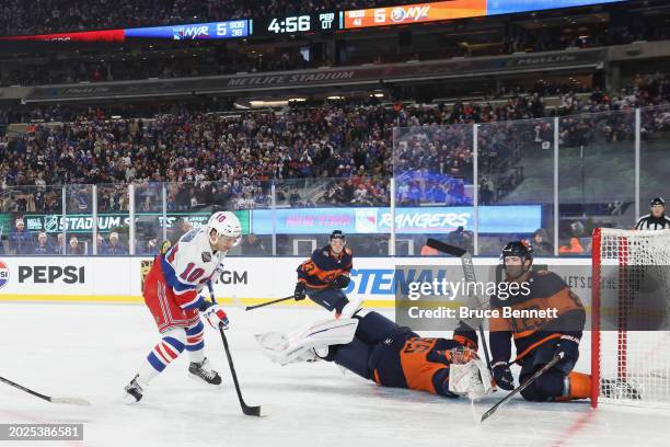 Artemi Panarin of the New York Rangers score sthe game-winning goal in overtime against the New York Islanders during the 2004 Navy Federal Credit...