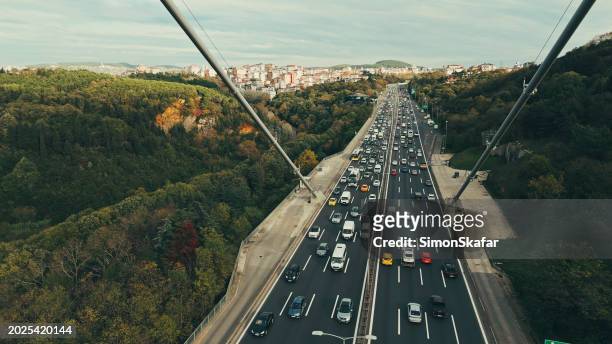 high angle view of traffic on bosphorus bridge amidst trees during daytime in istanbul,turkey - van turkey stock pictures, royalty-free photos & images
