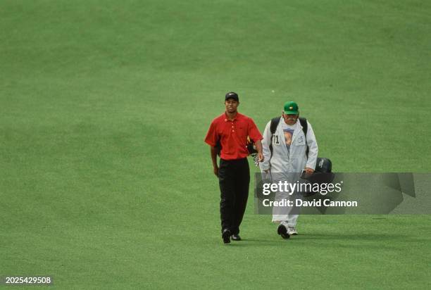 Tiger Woods from the United States walks with caddie Mike Fluff Cowan down the fairway during the 61st US Masters Tournament on 13th April 1997 at...