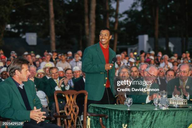 Tiger Woods from the United States makes his winners speech after being presented with the Masters Green Jacket from previous winner Nick Faldo...