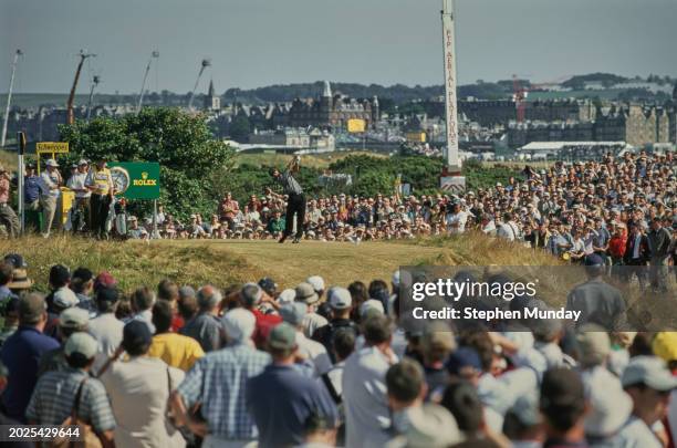 Spectators look on as Tiger Woods from the United States follows his drive off the tee during the second round of the 129th Open Championship on 21st...