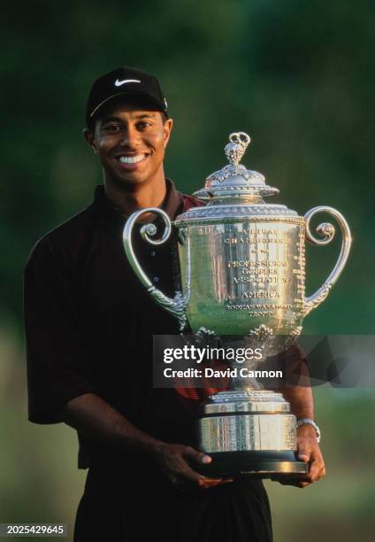 Tiger Woods from the United States holds the Wanamaker Trophy after winning the Professional Golfers' Association of America 82nd PGA Championship...