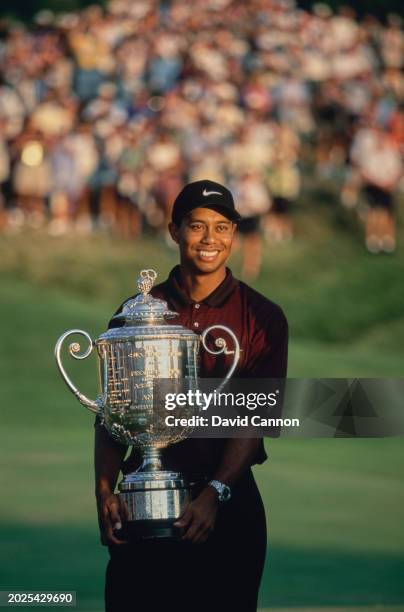 Tiger Woods from the United States holds the Wanamaker Trophy after winning the Professional Golfers' Association of America 82nd PGA Championship...
